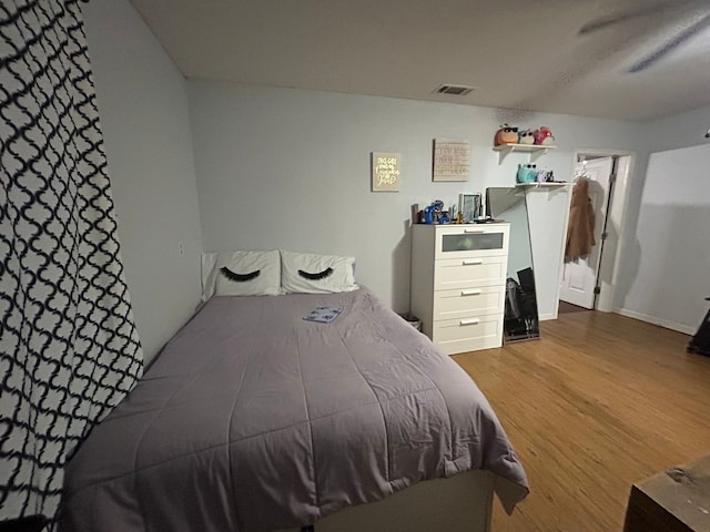 bedroom with hardwood / wood-style flooring