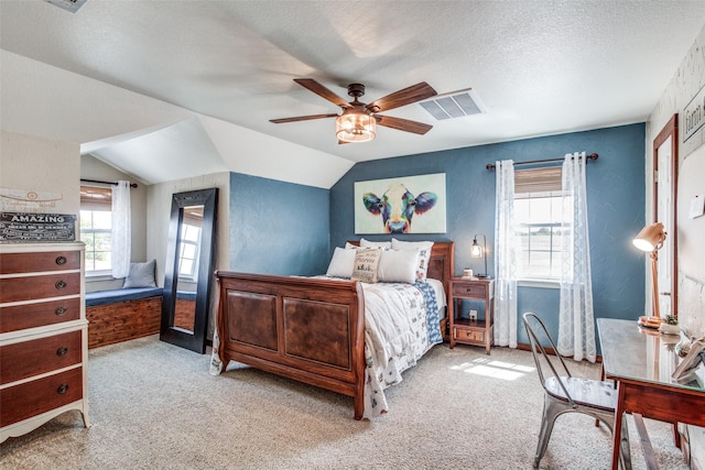 carpeted bedroom featuring ceiling fan, vaulted ceiling, and a textured ceiling