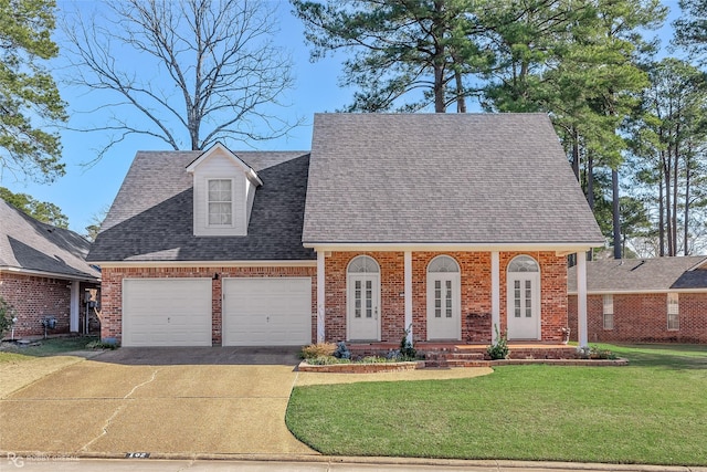 view of front of property with a garage and a front lawn