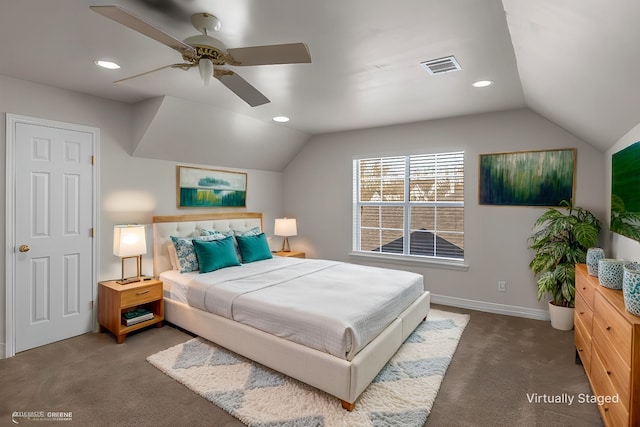 bedroom with dark carpet, vaulted ceiling, and ceiling fan