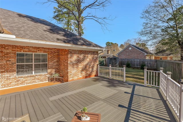 wooden terrace with a storage shed