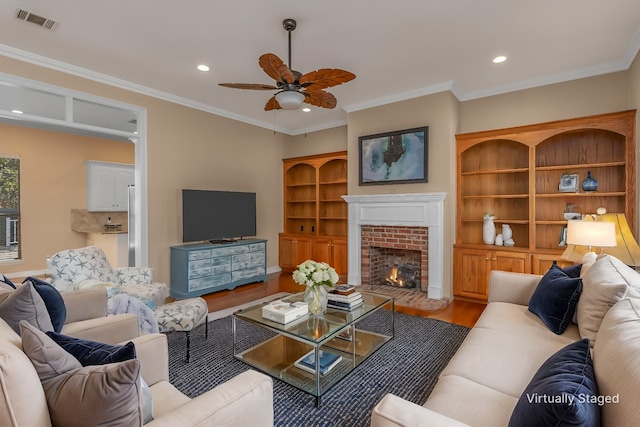 102 Hanging Moss Dr, Benton, LA 71006 - living area featuring visible vents, a ceiling fan, a fireplace, crown molding, and wood finished floors