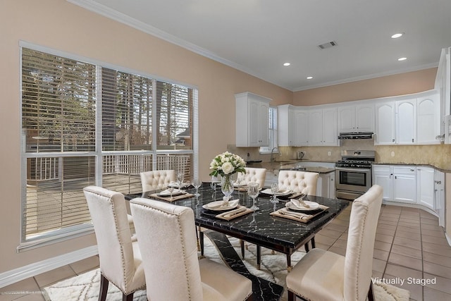 dining space featuring ornamental molding, sink, and light tile patterned floors