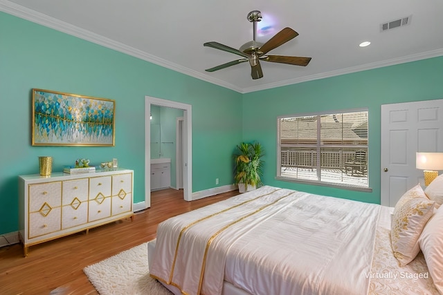 bedroom featuring hardwood / wood-style flooring, crown molding, ensuite bathroom, and ceiling fan