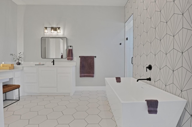 full bathroom with a soaking tub, a shower, baseboards, vanity, and tile patterned flooring