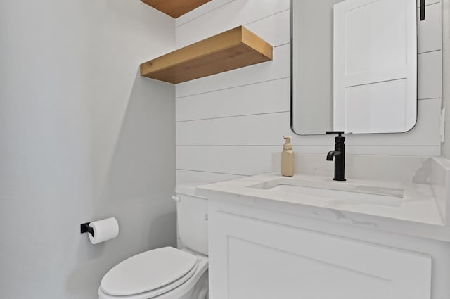 bathroom with toilet and vanity