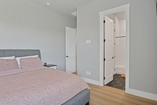 bedroom with baseboards and wood finished floors