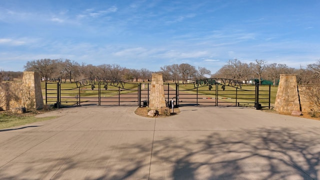 view of gate featuring a rural view and a yard