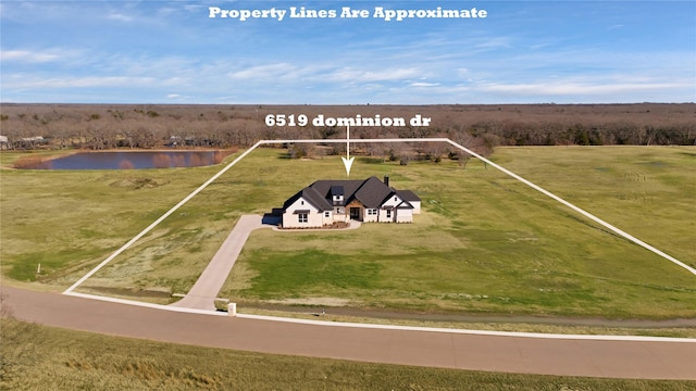 birds eye view of property featuring a rural view and a water view