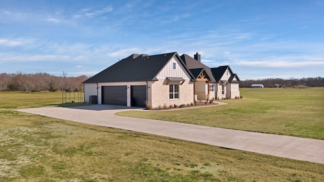 view of front of home with a chimney, a front lawn, driveway, board and batten siding, and an attached garage