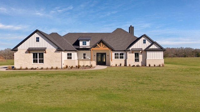 modern inspired farmhouse with board and batten siding, stone siding, a chimney, french doors, and a front lawn