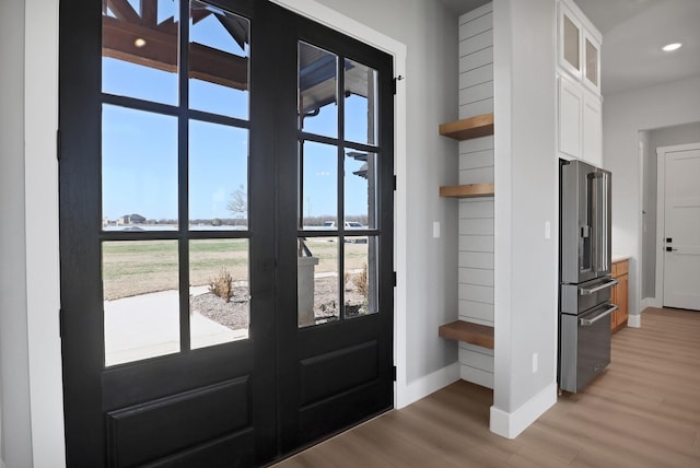 doorway with hardwood / wood-style floors and a wealth of natural light