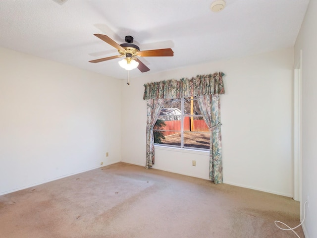 unfurnished room featuring light carpet and ceiling fan