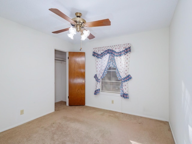 spare room featuring light carpet and ceiling fan