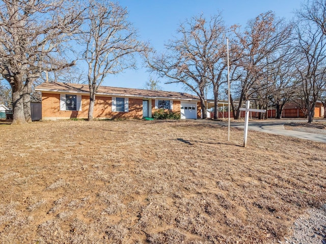 view of front of house featuring a garage and a front lawn