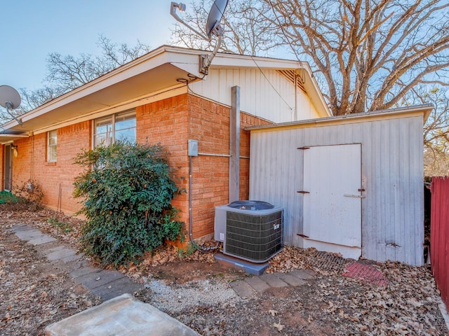 view of property exterior with a storage shed and central air condition unit