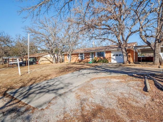 ranch-style house featuring a garage and a carport