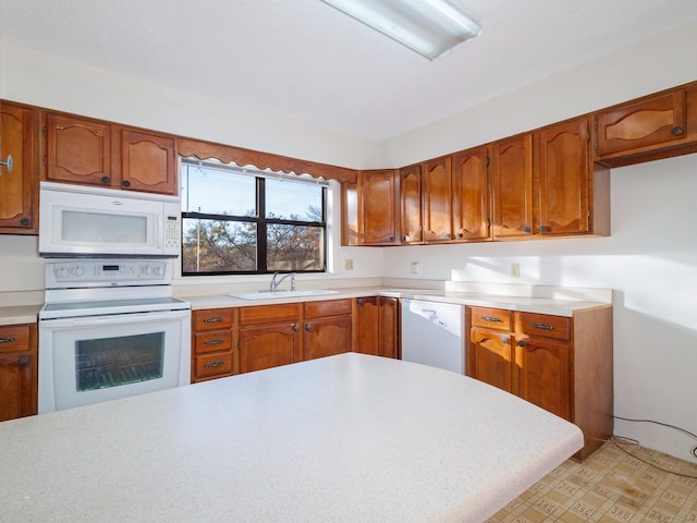 kitchen featuring white appliances and sink