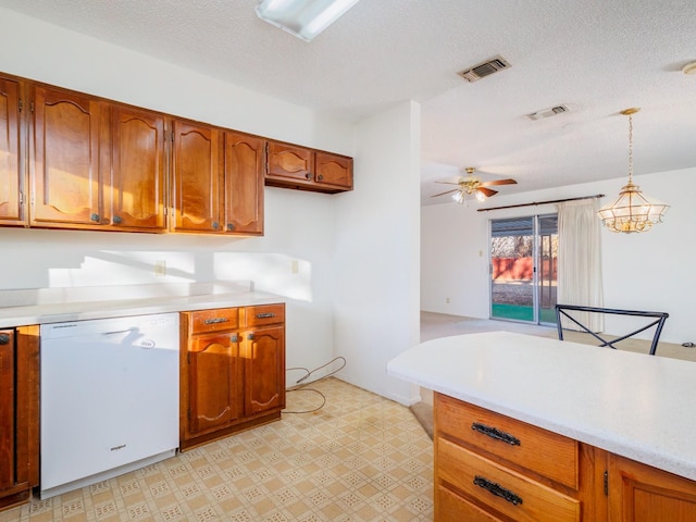 kitchen featuring dishwasher, pendant lighting, ceiling fan, and a textured ceiling