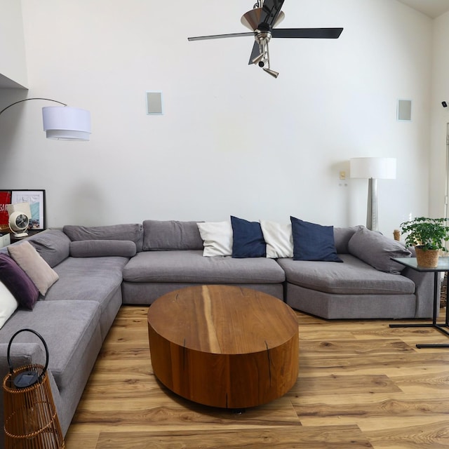 living room with ceiling fan and light wood-type flooring