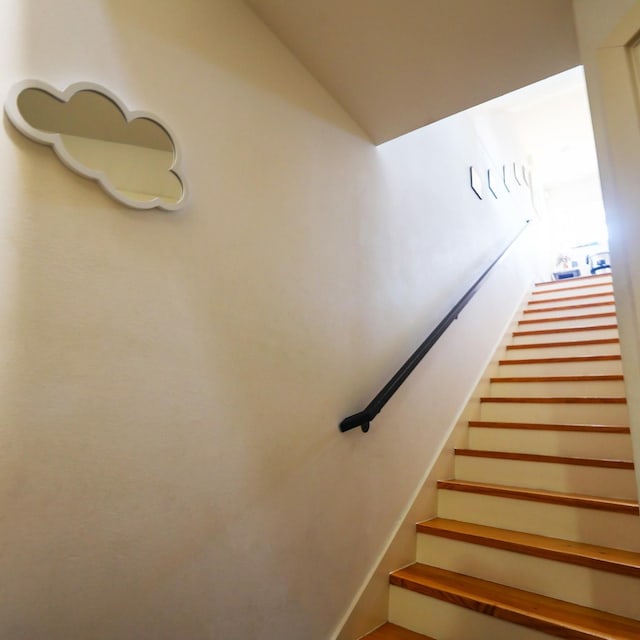 stairway featuring lofted ceiling