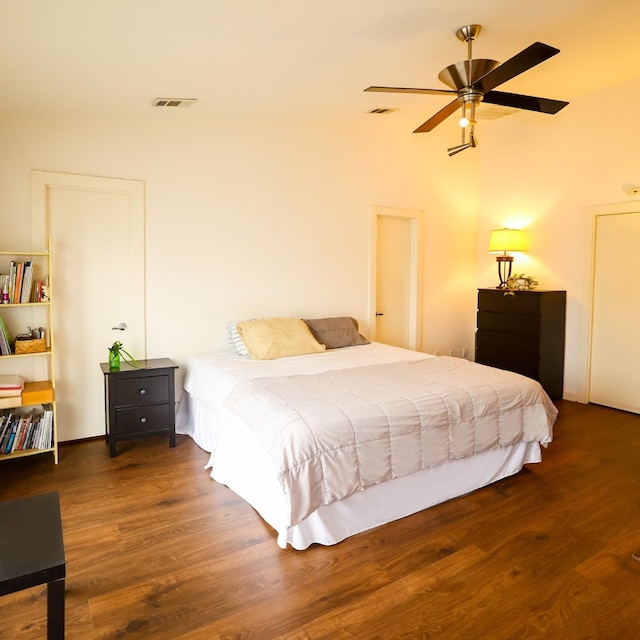 bedroom featuring visible vents and dark wood-type flooring