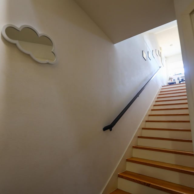 staircase with lofted ceiling