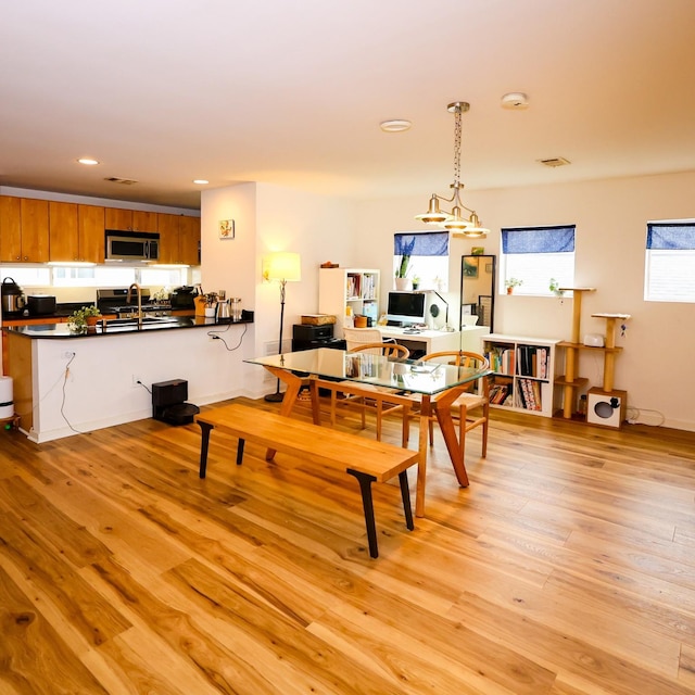 dining area featuring light wood-type flooring and recessed lighting