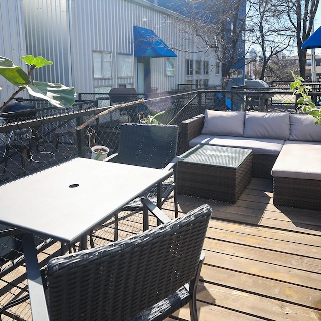 wooden deck with outdoor dining area and outdoor lounge area