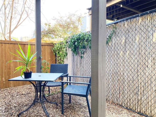 view of patio featuring fence