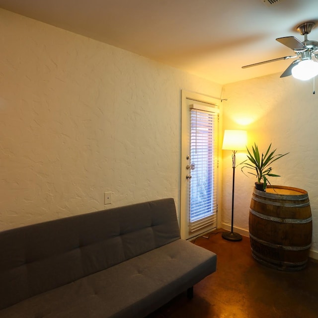 living area with ceiling fan and carpet floors