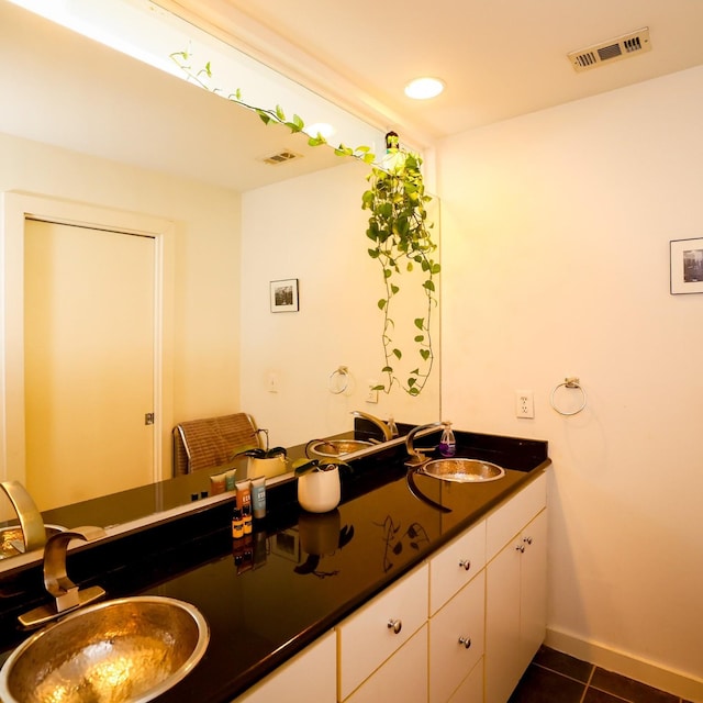 bathroom featuring tile patterned flooring, visible vents, baseboards, and vanity