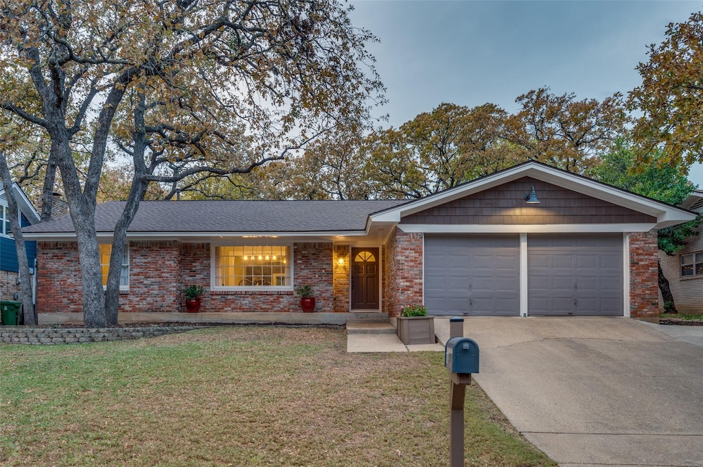 ranch-style home with a garage and a front yard