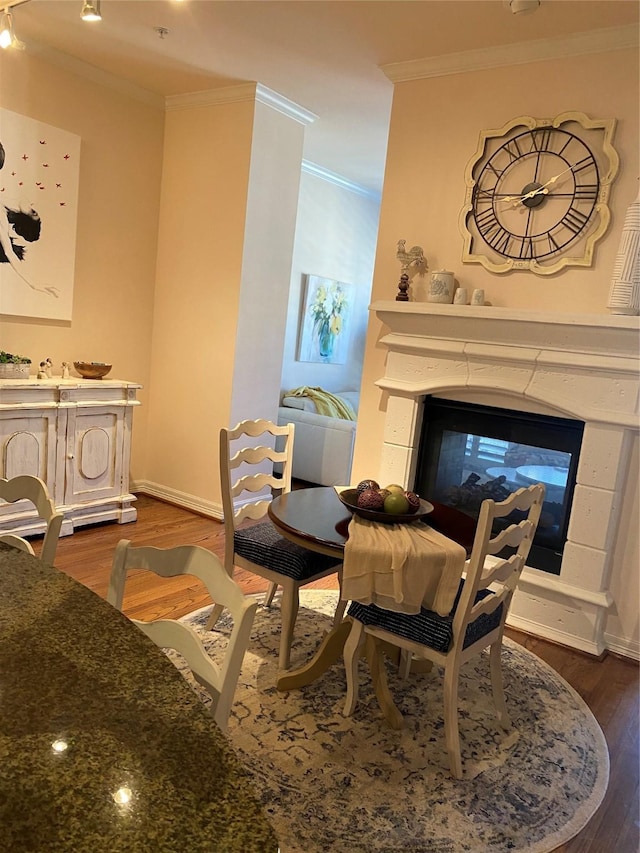 sitting room featuring crown molding, a multi sided fireplace, and dark hardwood / wood-style flooring