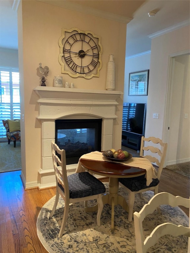 living room with hardwood / wood-style flooring, a multi sided fireplace, and ornamental molding