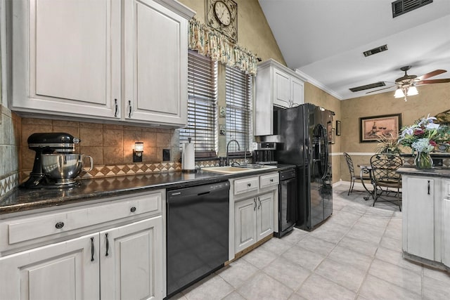 kitchen with white cabinets, sink, vaulted ceiling, and black appliances