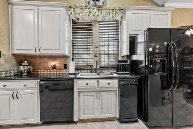 kitchen with white cabinetry, sink, tasteful backsplash, and black appliances