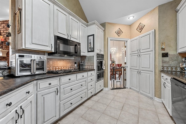 kitchen with vaulted ceiling, light tile patterned flooring, white cabinetry, backsplash, and black appliances