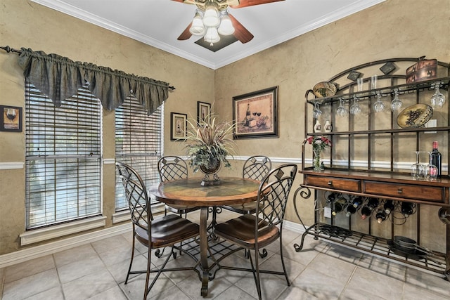 dining space featuring ceiling fan, ornamental molding, and tile patterned flooring