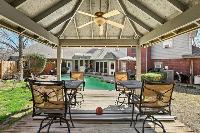 wooden deck featuring a fenced in pool, a gazebo, central AC unit, and ceiling fan