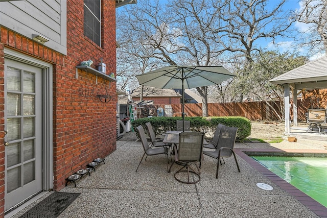 view of patio / terrace with a fenced in pool