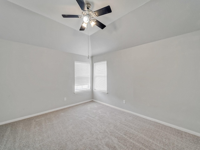 spare room featuring lofted ceiling, carpet flooring, and ceiling fan