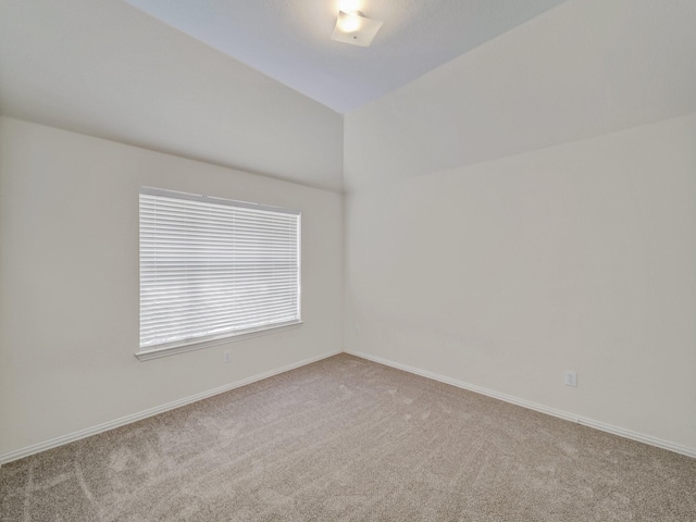 spare room featuring light carpet