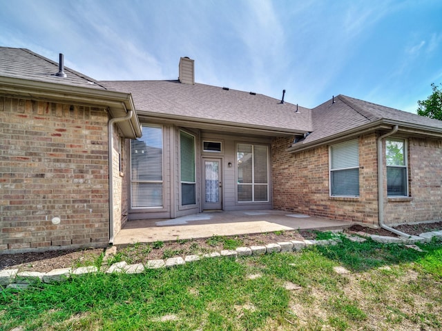 back of property with a patio