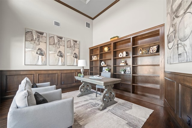 office area with dark hardwood / wood-style flooring, crown molding, and high vaulted ceiling