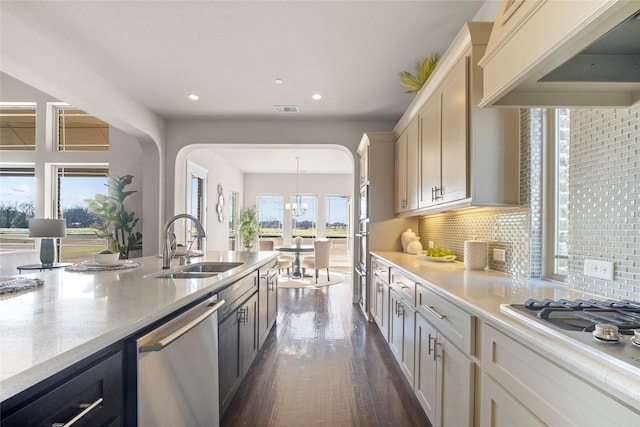 kitchen with pendant lighting, sink, stainless steel dishwasher, custom exhaust hood, and white gas cooktop