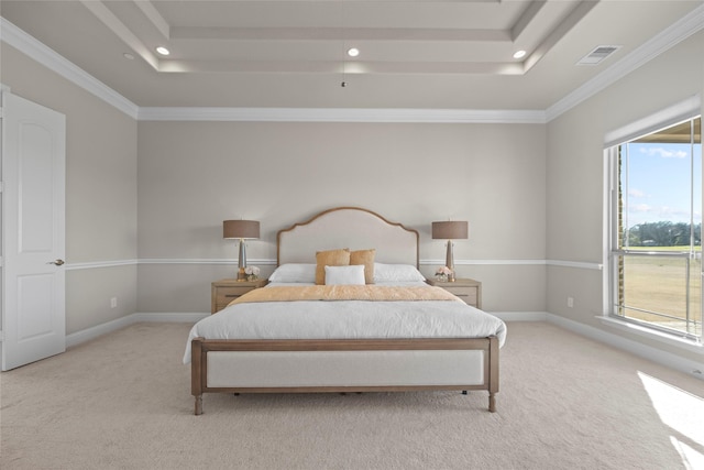 bedroom featuring crown molding, a tray ceiling, and light colored carpet