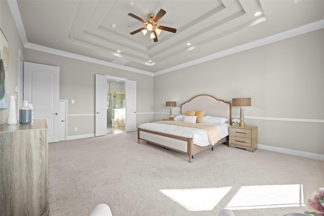 carpeted bedroom with ceiling fan, ensuite bath, ornamental molding, and a raised ceiling