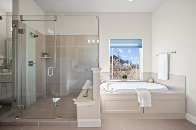 bathroom with tile patterned flooring, separate shower and tub, and a chandelier