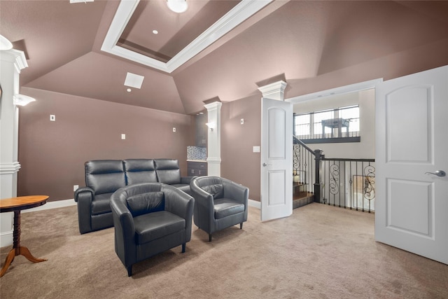 carpeted home theater room with high vaulted ceiling and decorative columns